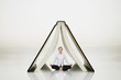 Businesswoman meditating under a book