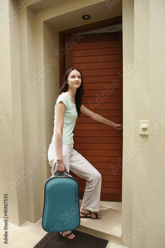 Photo: Woman entering room Woman entering room