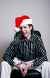Foto: Businessman with christmas hat sitting on the chair laughing Businessman with christmas hat sitting on the chair laughing