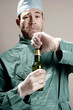 Doctor opening a bottle of alcohol