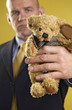 Businessman holding a teddy bear
