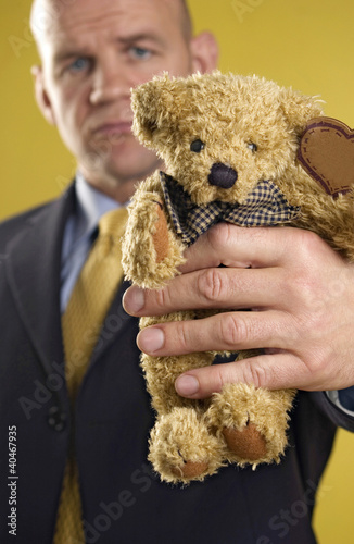 Photo: Businessman holding a teddy bear Businessman holding a teddy bear