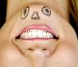 Woman with a face drawn on her chin