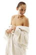 Woman in white bathrobe smiling while thinking