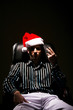Foto: Businessman with christmas hat smoking cigarette Businessman with christmas hat smoking cigarette
