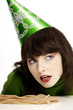 Woman in party hat with licorice on the table
