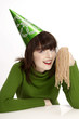 Woman in party hat holding licorice