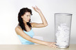 Woman throwing crumpled paper into the dustbin