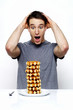 Man in shock looking at a stack of doughnuts