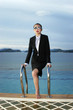 Businesswoman in goggles climbing out from the swimming pool