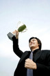 Businessman lifting up his trophy