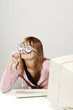 Businesswoman with cardboard cutout spectacles thinking