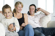 Boy and father listening to music with his mother sitting in between