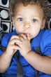 Boy sitting on baby chair with seat belt
