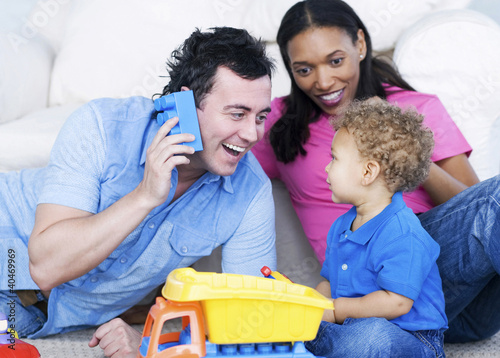Photo: Young parents playing with their son Young parents playing with their son