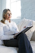 A confident looking business lady sitting on a couch