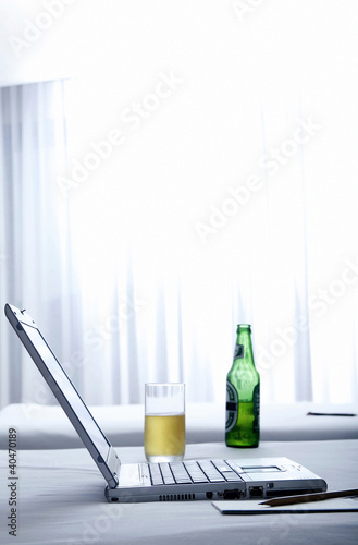 Photo: Laptop and beer on the bed Laptop and beer on the bed