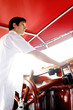 Man at helm of yacht