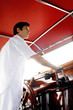 Man at helm of yacht