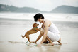 Man playing with his dog on the beach
