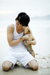 Man playing with his dog on the beach