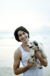 Man posing with his dog on the beach
