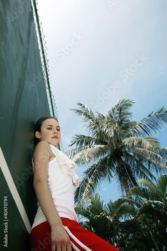 Photo: Woman standing in the tennis court Woman standing in the tennis court
