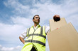 Low angle view of a delivery man beside some boxes