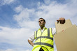 Low angle view of a delivery man beside some boxes