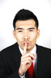 Businessman with finger on lips