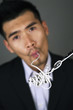 Businessman sipping in computer cable