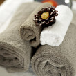Scented candle on rolled up towels