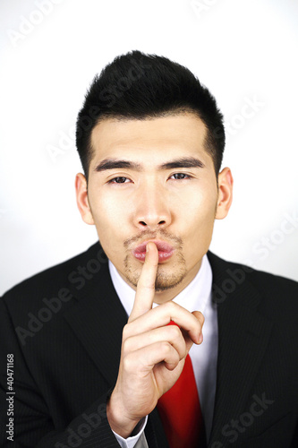 Photo: Businessman with finger on lips Businessman with finger on lips