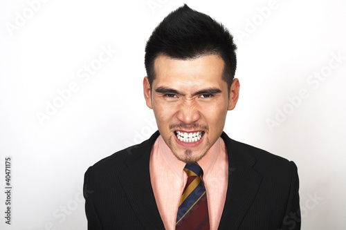 Photo: Angry businessman clenching teeth Angry businessman clenching teeth