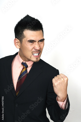 Foto: Angry businessman clenching teeth Angry businessman clenching teeth