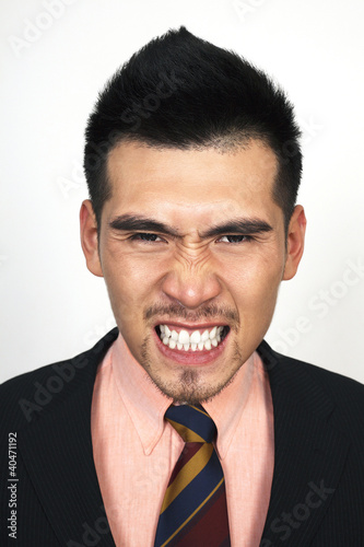 Photo: Angry businessman clenching teeth Angry businessman clenching teeth