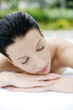 Woman lying forward on massage table with her eyes closed