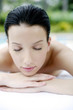 Woman lying forward on massage table with her eyes closed