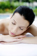 Woman lying forward on massage table with her eyes closed
