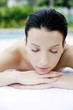 Woman lying forward on massage table with her eyes closed