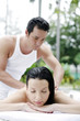 Woman getting a body massage at the pool side