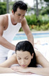 Woman getting a body massage at the pool side