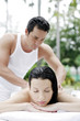 Woman getting a body massage at the pool side