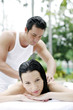 Woman getting a body massage at the pool side