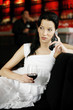 Woman talking on the mobile phone while holding a glass of wine
