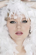 Young woman with white feathers posing for the camera