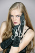Young woman holding pearl necklace