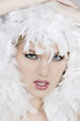 Young woman with white feathers posing for the camera
