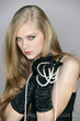 Young woman holding pearl necklace