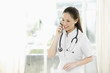 Photo: Female doctor talking on the phone Female doctor talking on the phone